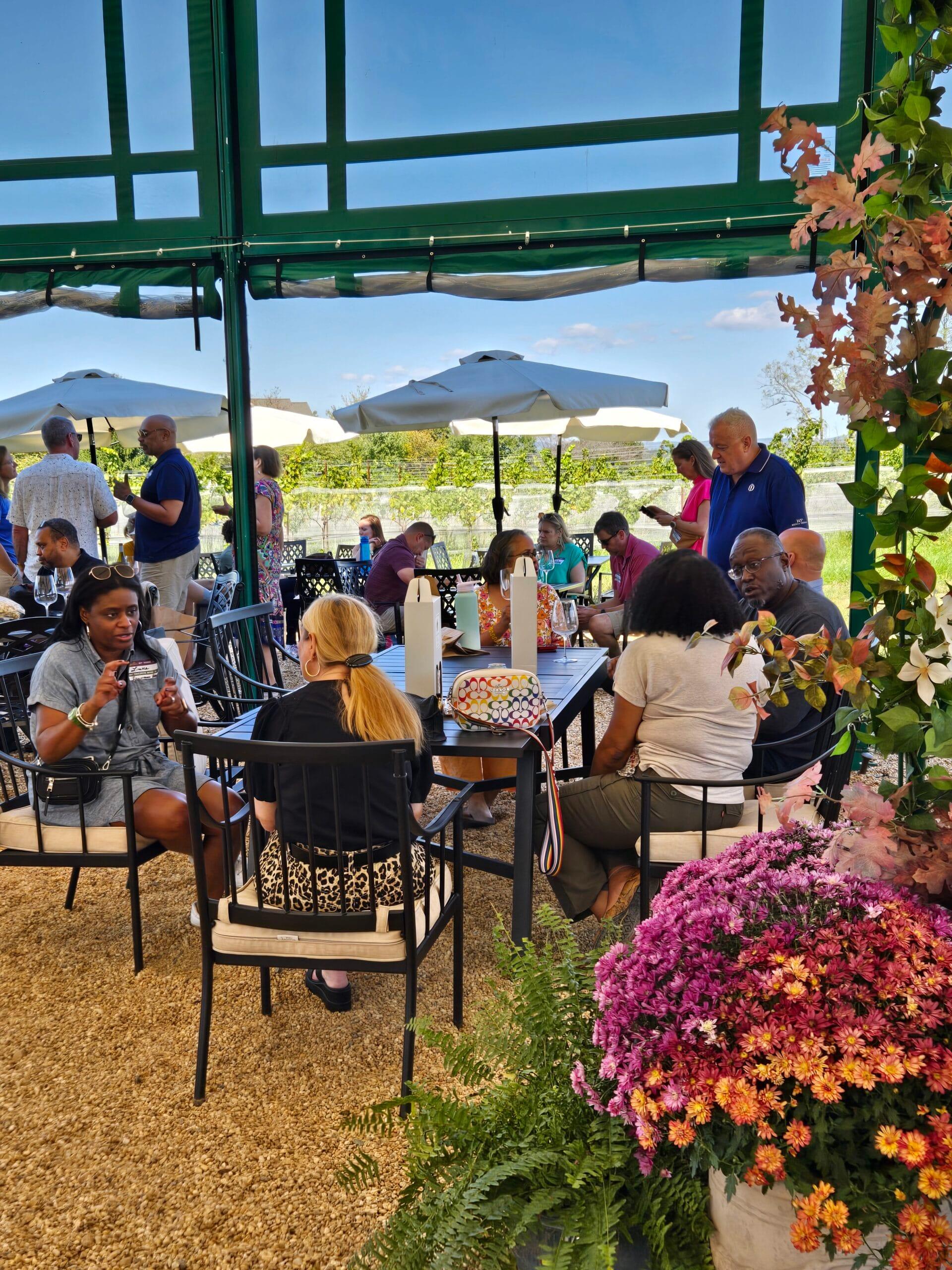 Guests sharing wine and conversation outdoors at a Virginia winery