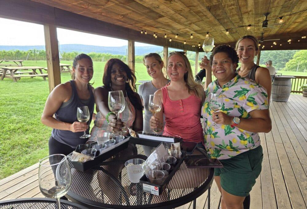 Friends smiling together during a winery celebration