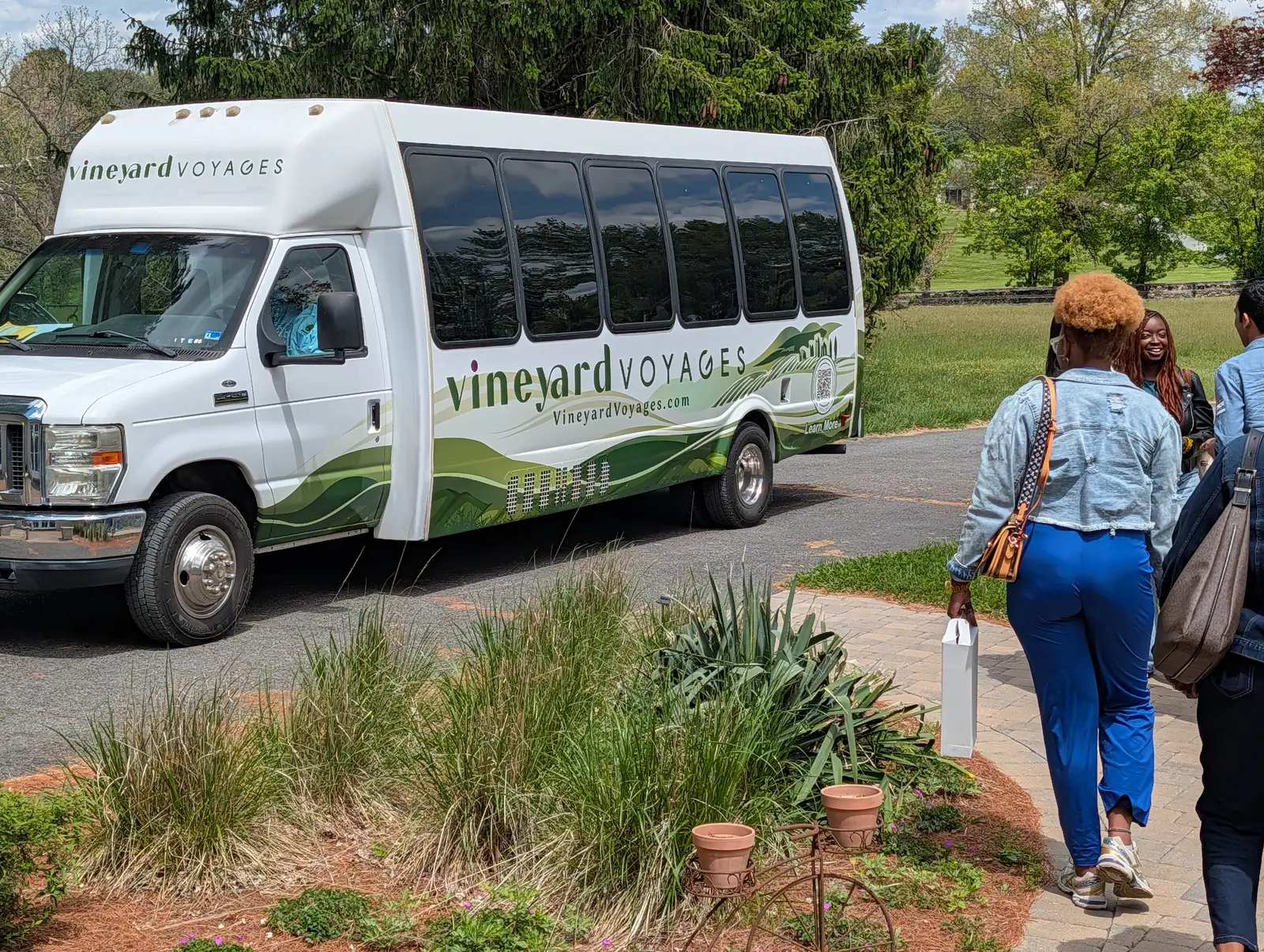 Guests walking to the Vineyard Voyages bus after a winery stop