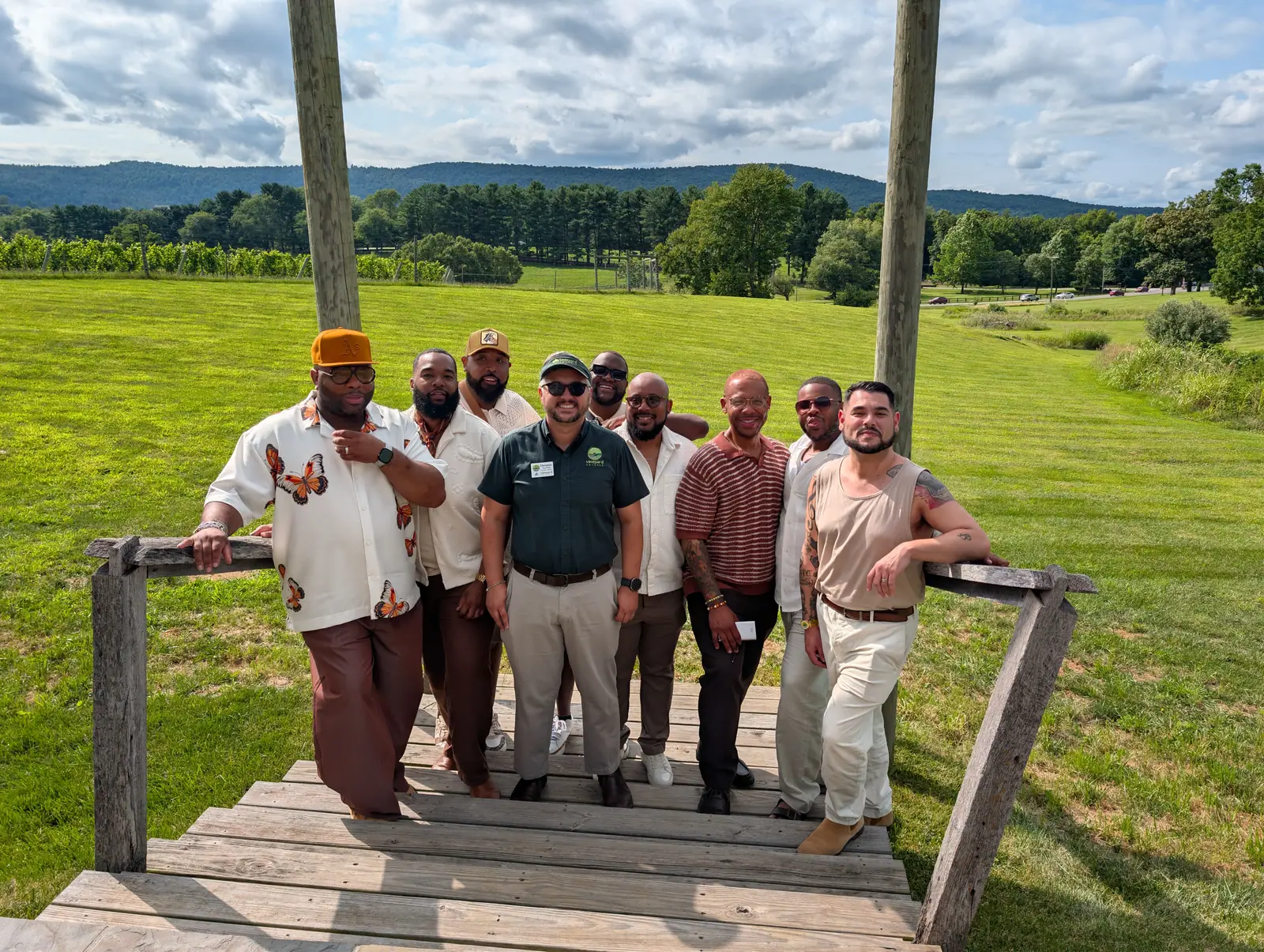 A corporate group photographed together on a winery porch