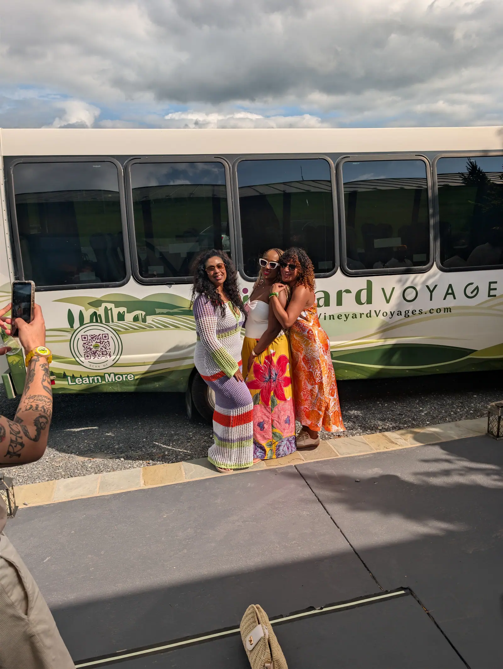 Two friends photographed beside the Vineyard Voyages bus