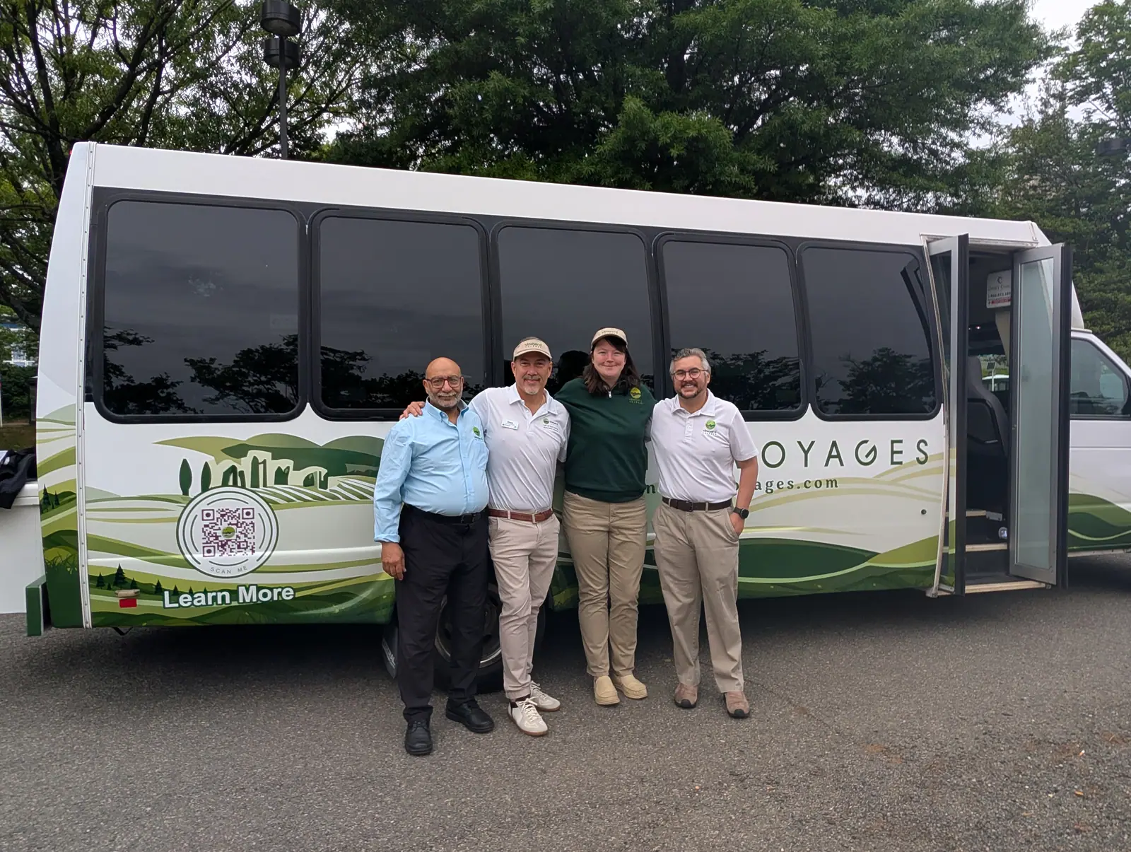 The Vineyard Voyages team standing in front of the 27-seat executive bus