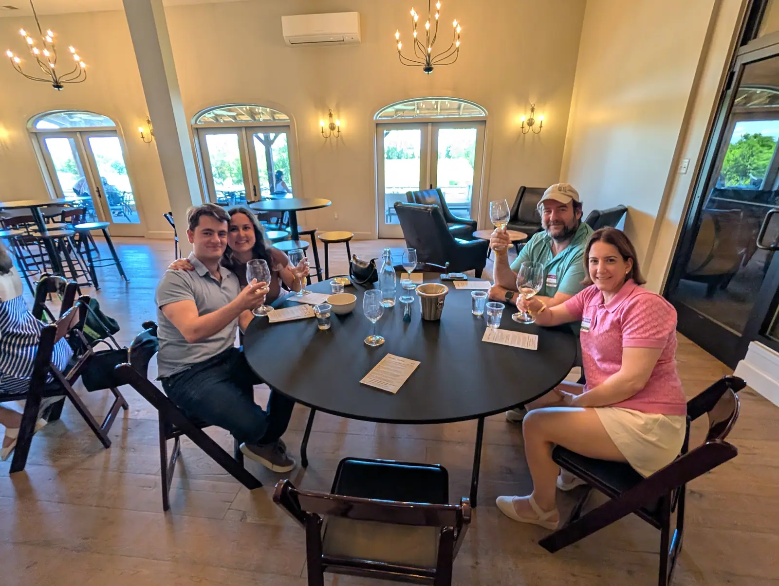 Colleagues toasting around a round tasting table