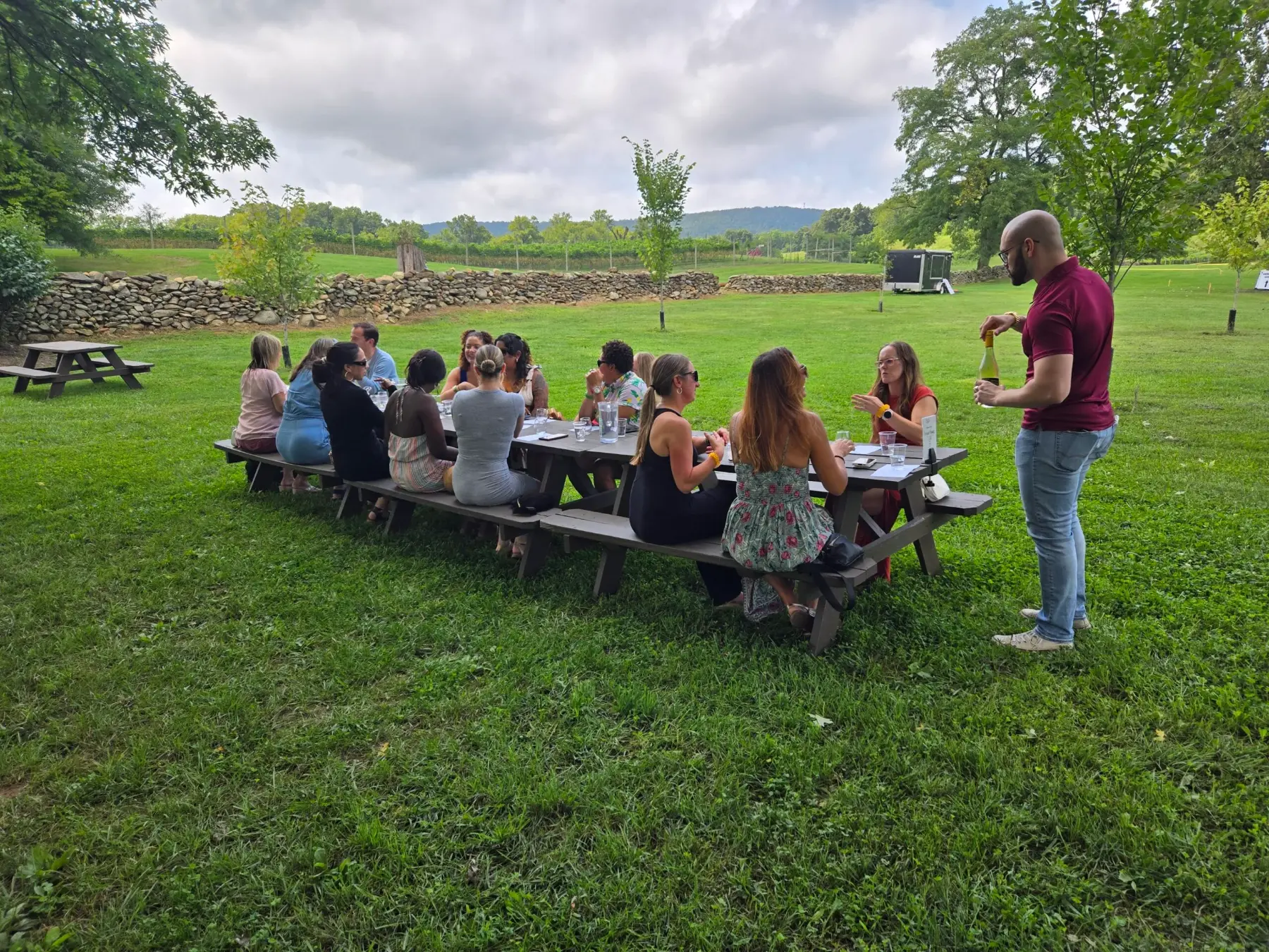 Colleagues connecting around vineyard tables during a Virginia wine country team outing