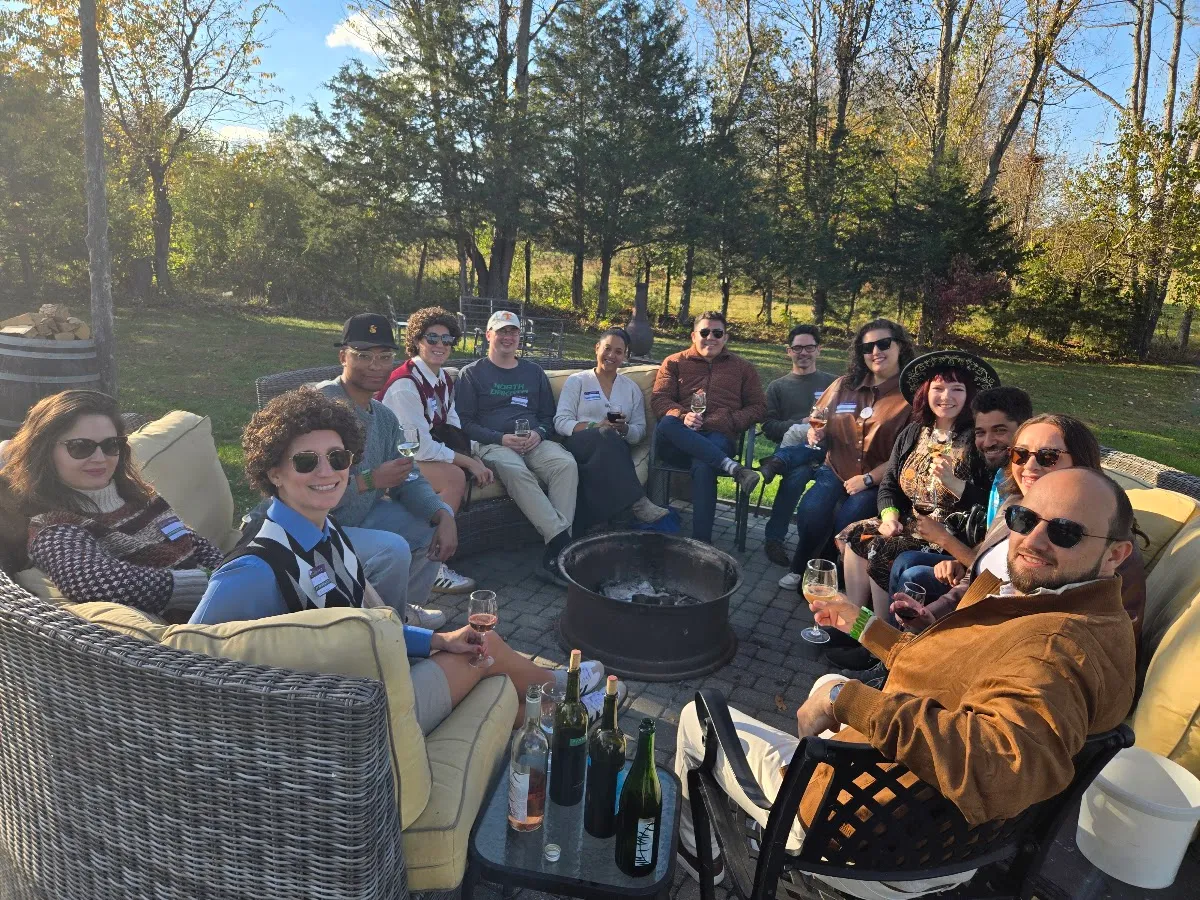 A Vineyard Voyages group sharing wine around a fire pit at Fabbioli Cellars