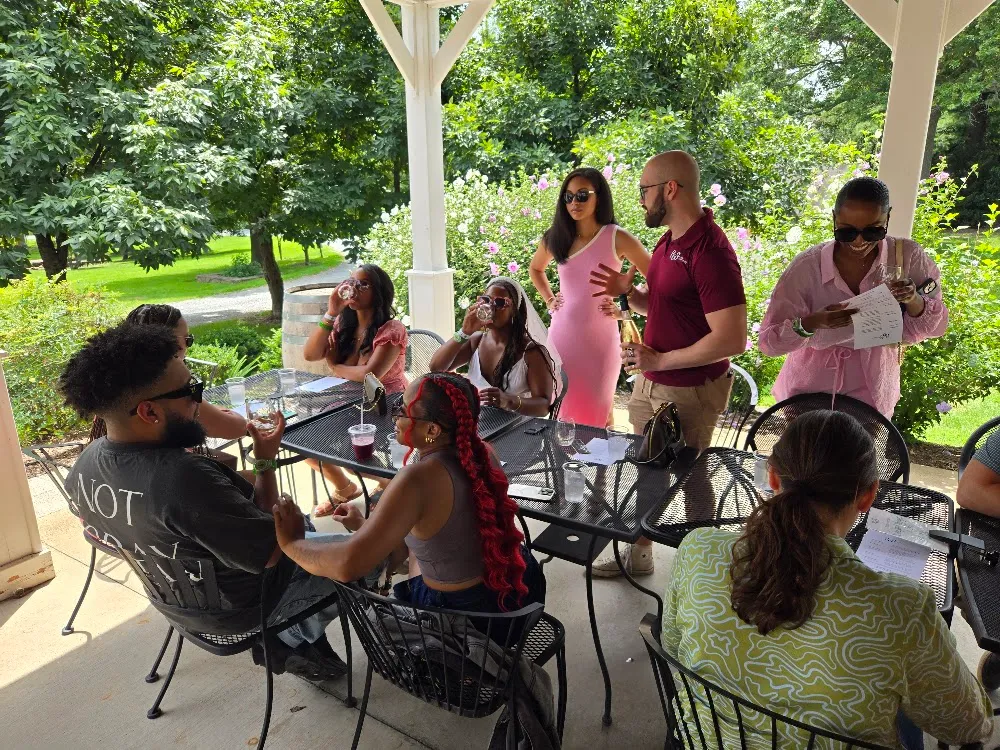 Guests sharing wine under the pavilion at 868 Estate Vineyards