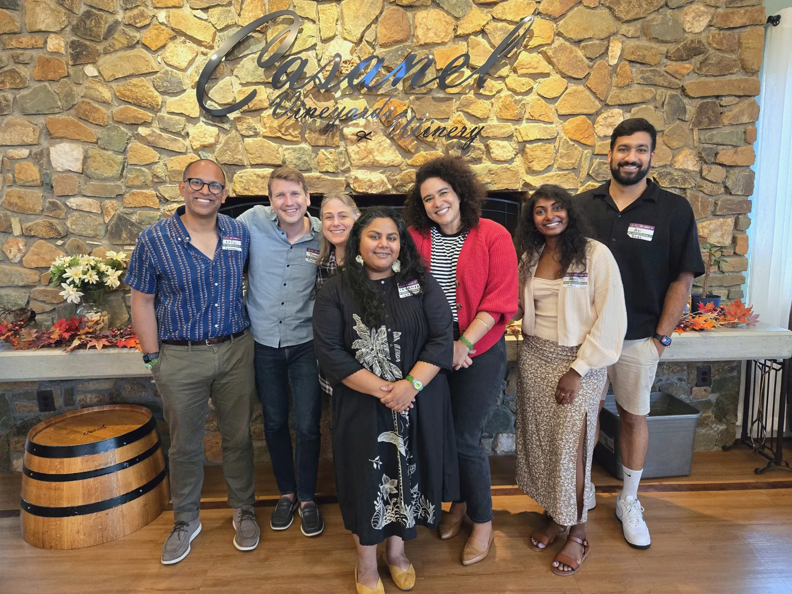 Vineyard Voyages guests smiling in front of the Casanel Vineyards & Winery sign
