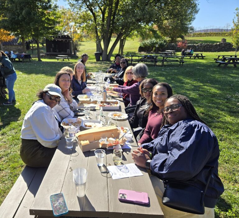 Guests sharing lunch at a long winery table